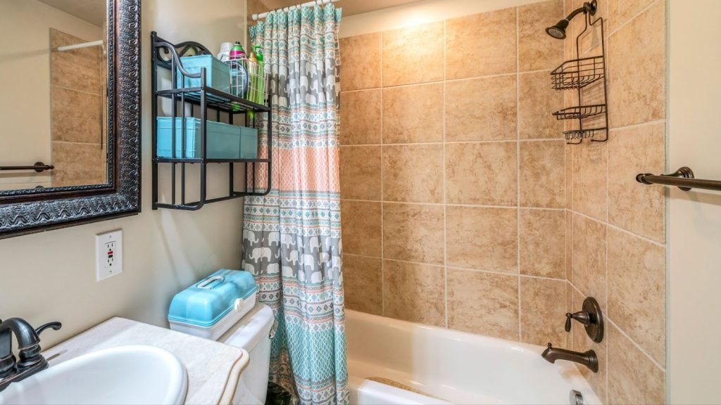 A bathroom featuring a shower, toilet, and sink. Ideal for bathroom vanity remodels and cabinet remodeling projects